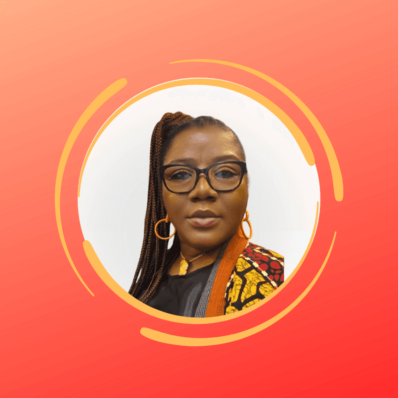 Woman with long braids and glasses wearing orange hoop earrings in a circular frame.